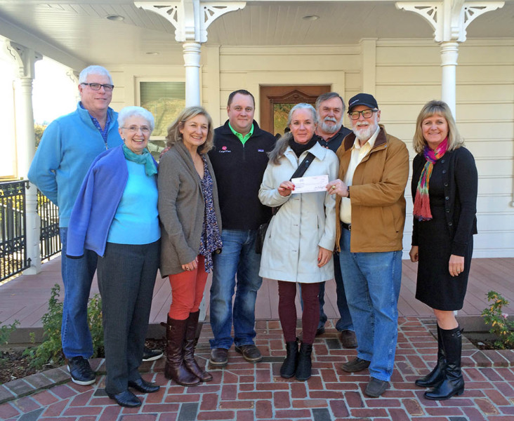 Carpe Vino co-owner Gary Moffat presents a check for $5,000 to Placer Community Foundation board member, Ellen MacInnes, on the front porch of the company offices in a restored Victorian in Old Town Auburn. Pictured from left, PCF board members Larry Welch, Ruth Burgess and Pam Constantino; Carpe Vino co-owner Drew Moffat; Ellen MacInnes; PCF board member Ken Larson; Gary Moffat; and PCF CEO Veronica Blake.  